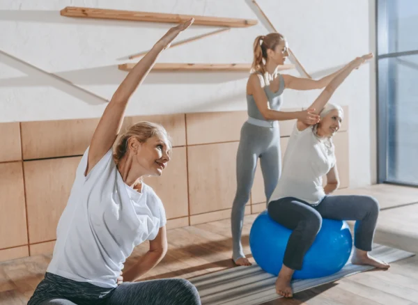 group-of-senior-people-exercising-with-fitness-bal-physiozen