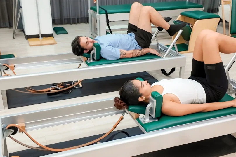 pilates-instructor-performing-fitness-exercise-on-physiozen